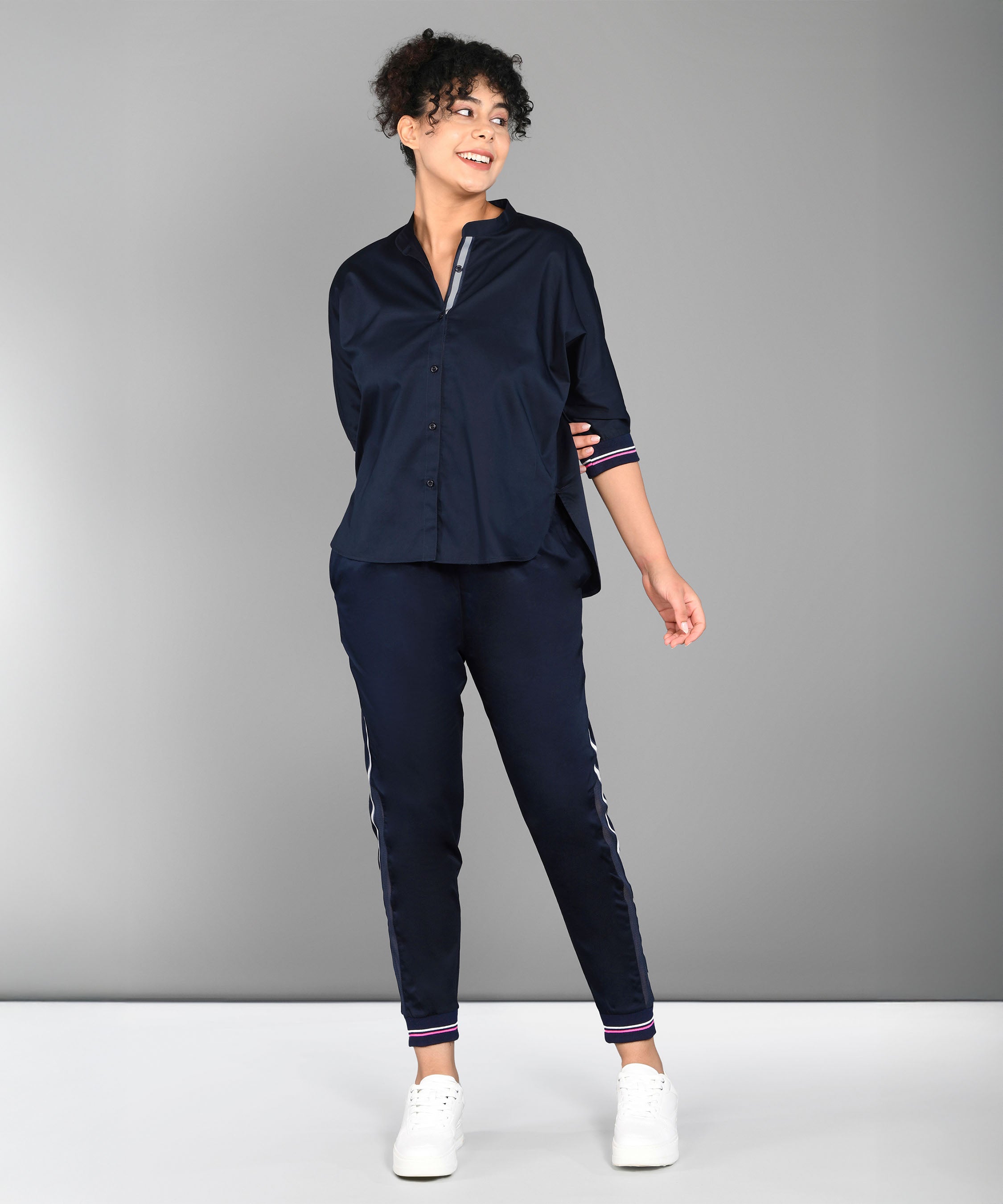 Trendy matching outfits for women featuring a navy shirt and stylish joggers with stripes