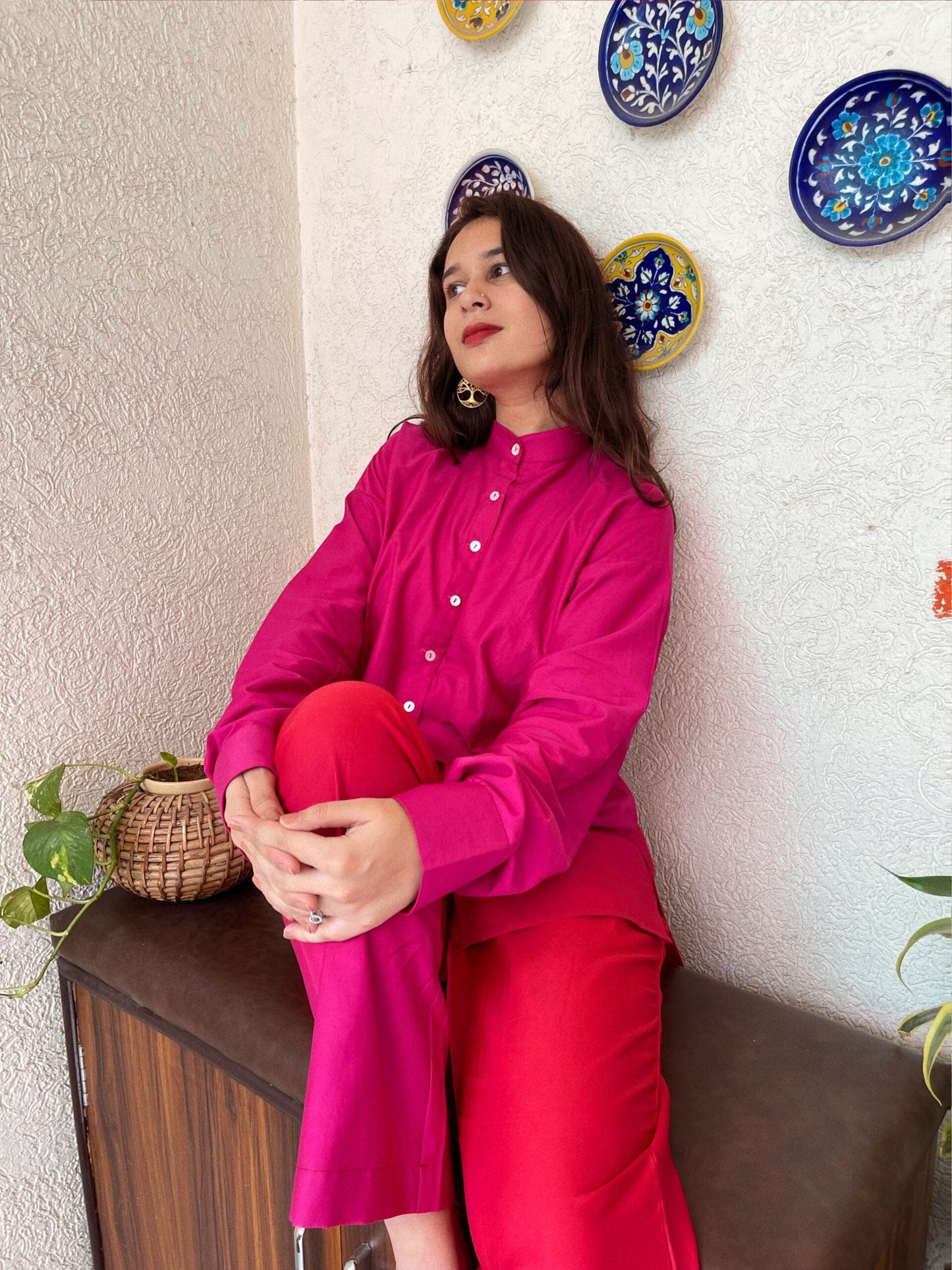 Trendy matching outfits for women featuring a pink button-up shirt and red pants