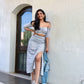 Woman wearing Stylera trendy matching skirt and top co-ord set with checkered pattern and side slit
