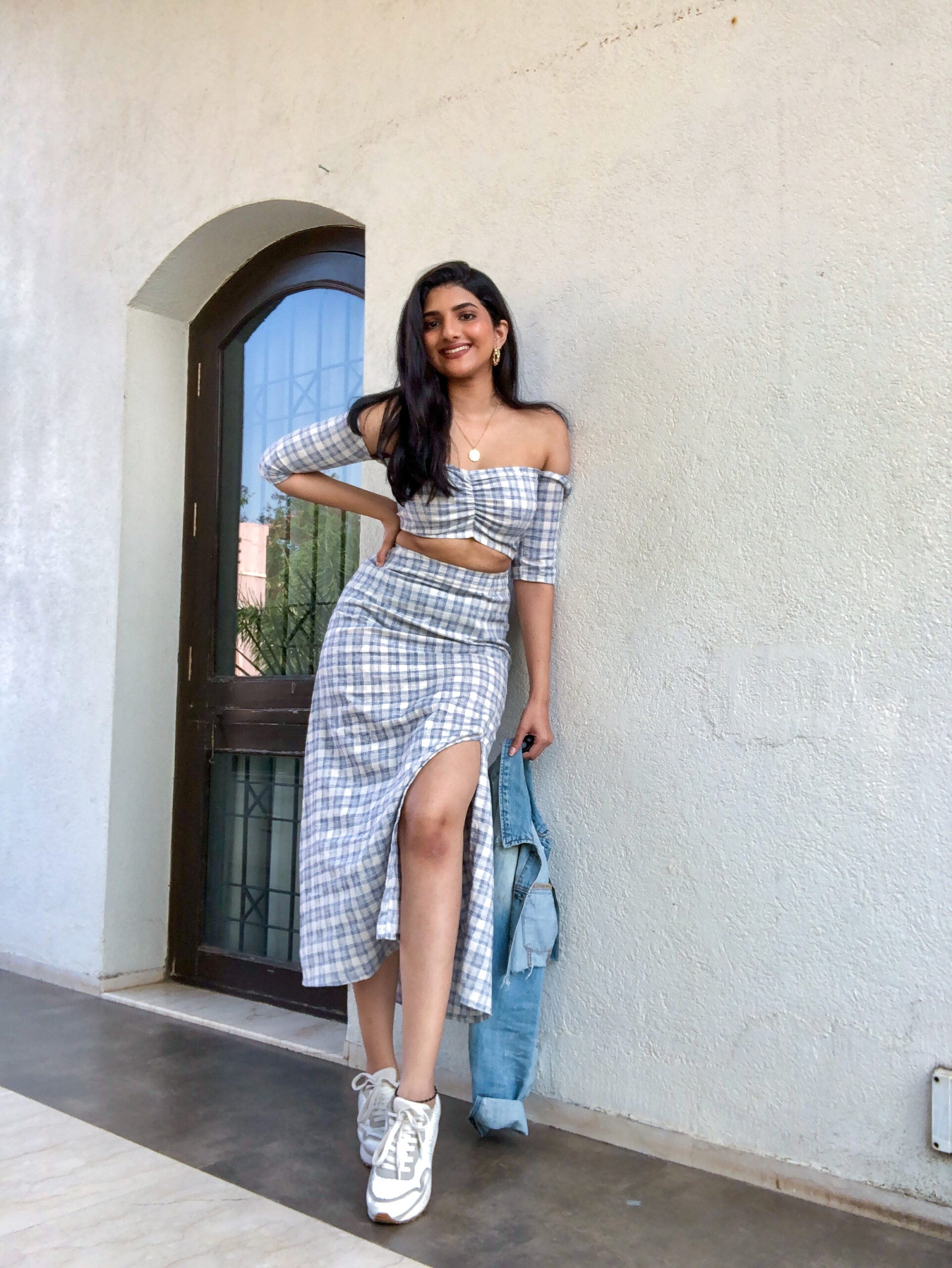 Woman wearing Stylera trendy matching skirt and top co-ord set with checkered pattern and side slit
