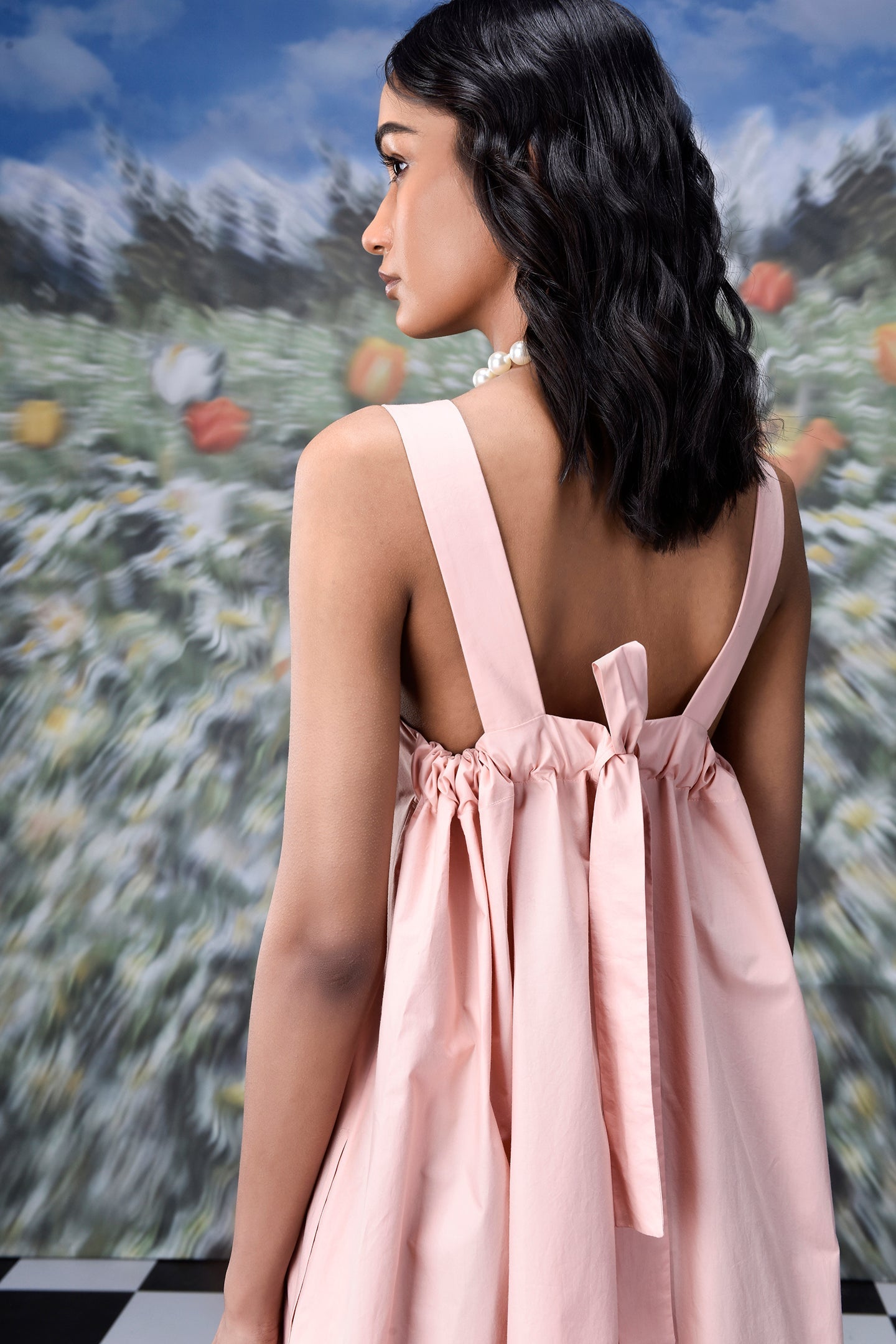 Back view of model in pale pink gathered bow back dress with wide straps trendy maxi dress for women