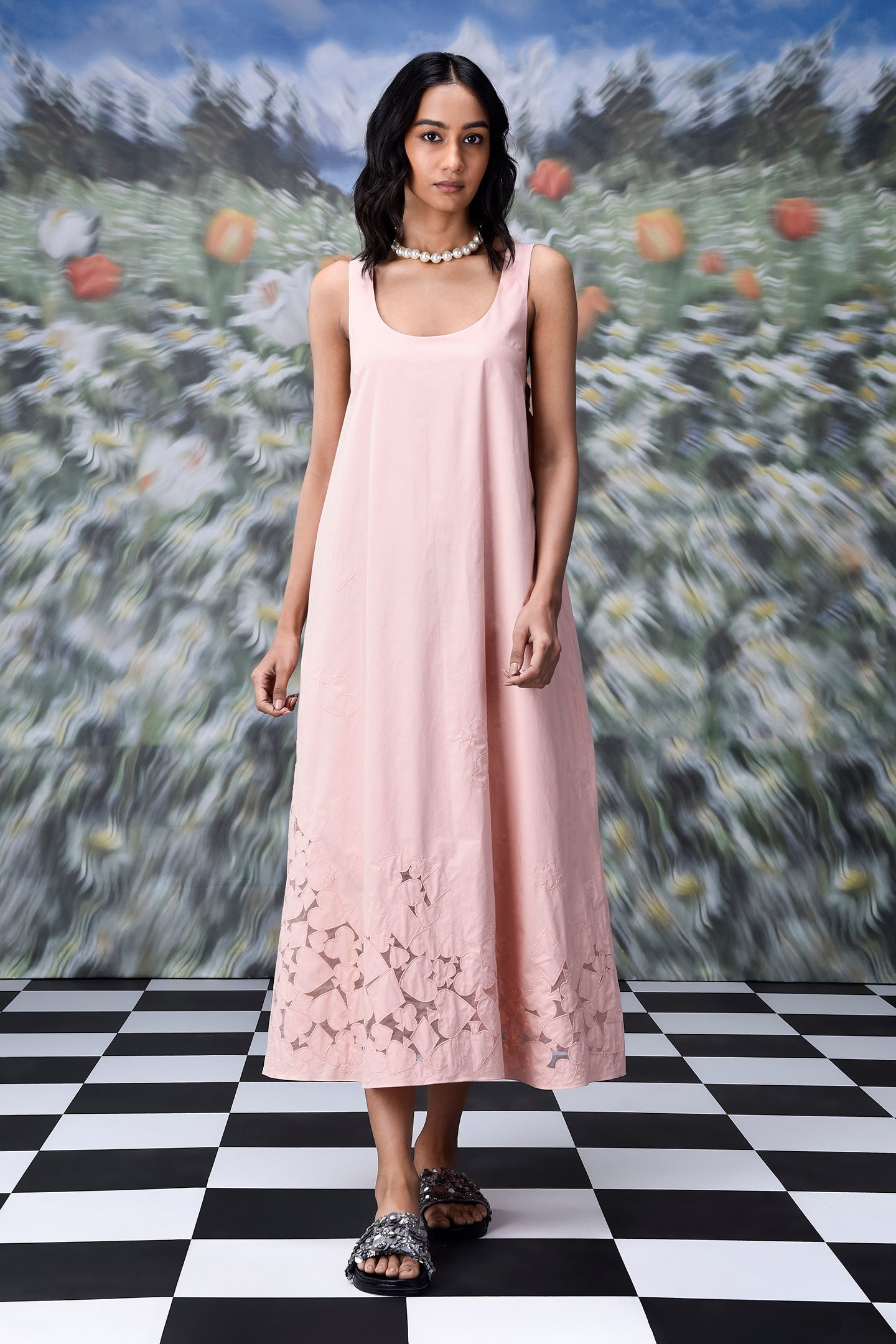 Stylera pale pink sleeveless scoop neck dress with laser cut hem on model wearing trendy maxi dress for women