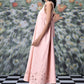 Stylera pink sleeveless A line maxi dress with cutout hem on model on checkered floor trendy maxi dress for women