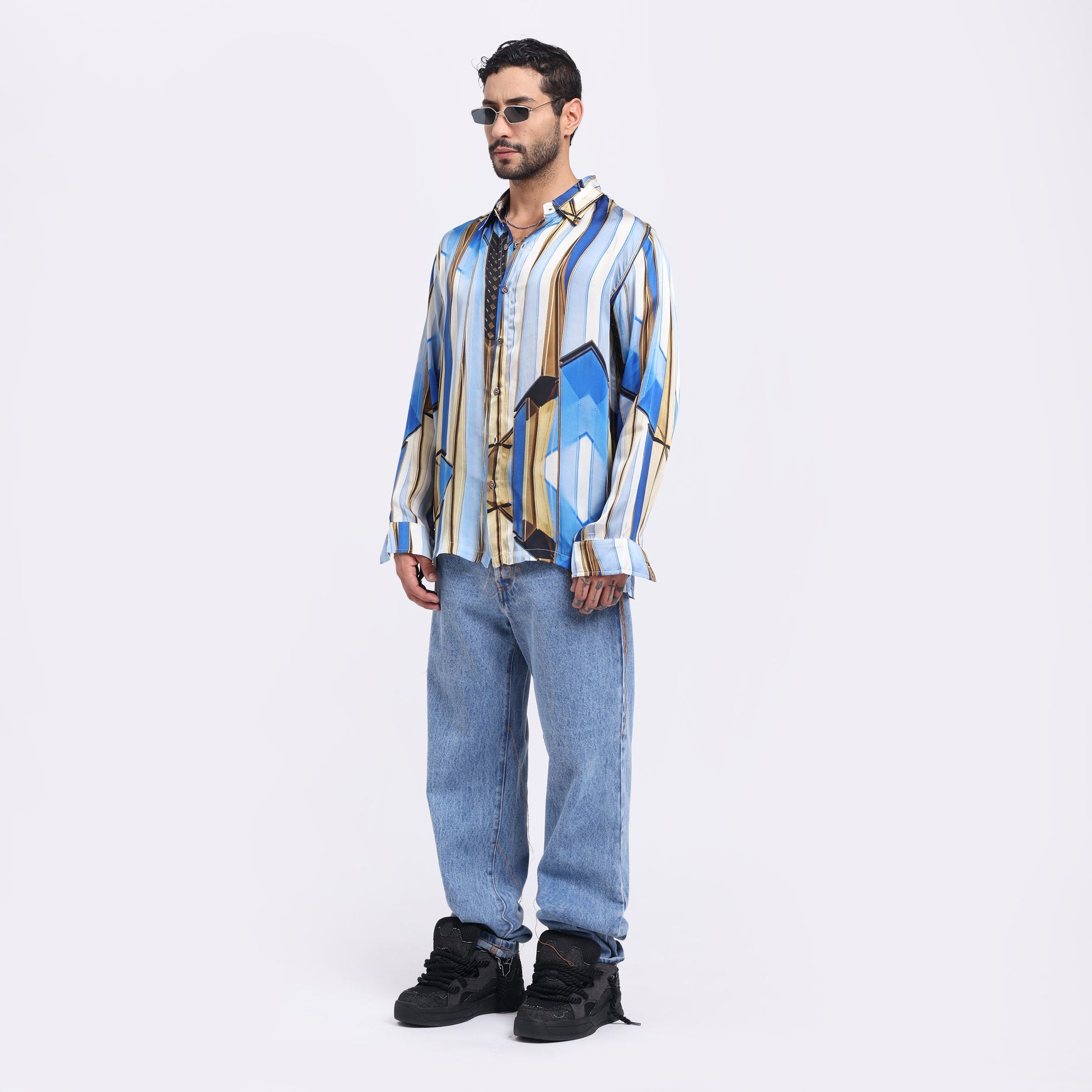 Stylera trendy men's long sleeve shirt in blue and yellow geometric pattern, styled with jeans and sunglasses