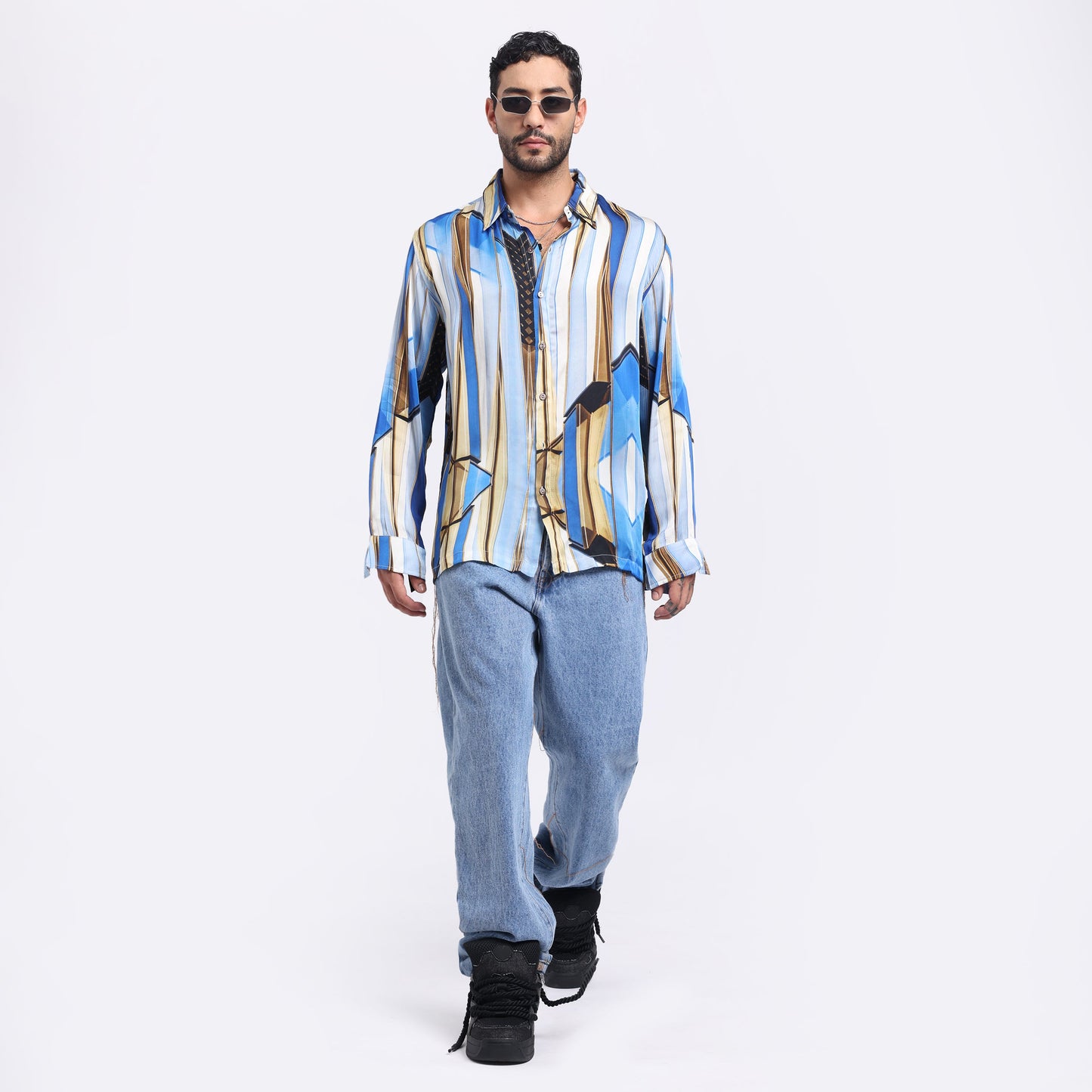 Stylera trendy men's long sleeve shirt in blue and gold stripes, styled with light jeans and sunglasses