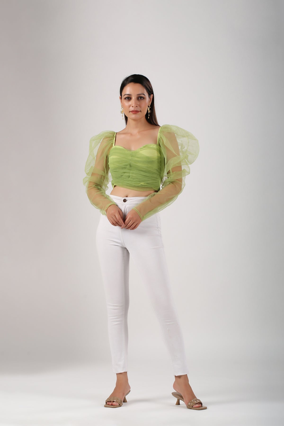 Trendy mesh crop top for women in green with long puff sleeves, paired with white high-waisted pants