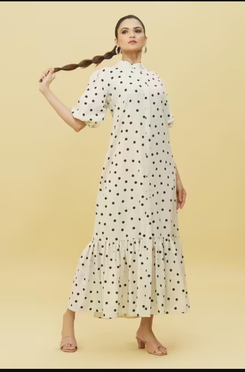 Model wearing Stylera white polka dot trendy midi dress for women with high neck puff sleeves and ruffle hem