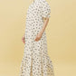 Model wearing Stylera ivory polka dot trendy midi dress for women with puff sleeves high neck ruffle hem