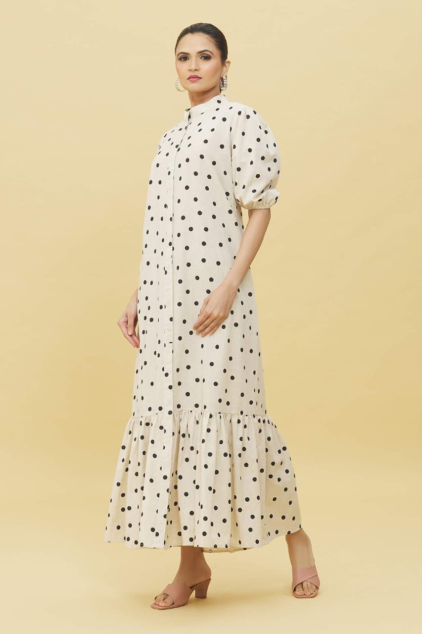 Model wearing Stylera ivory polka dot trendy midi dress for women with puff sleeves high neck ruffle hem
