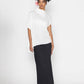 Stylera trendy minimalist women’s top in white paired with a long black skirt