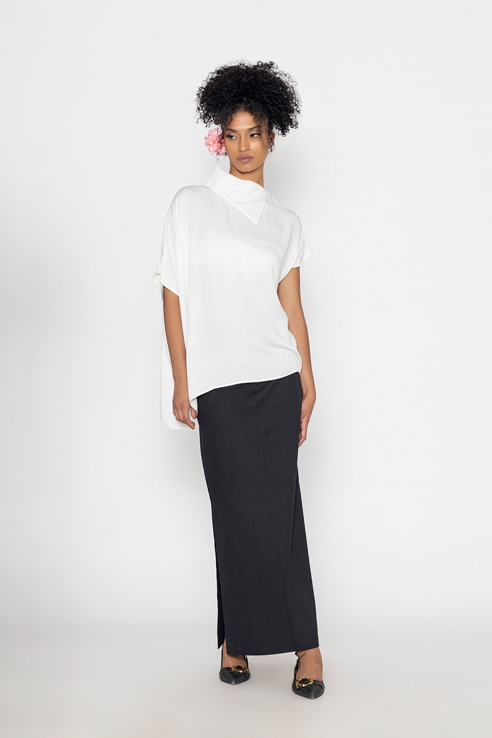 Stylera trendy minimalist women’s top in white paired with a long black skirt