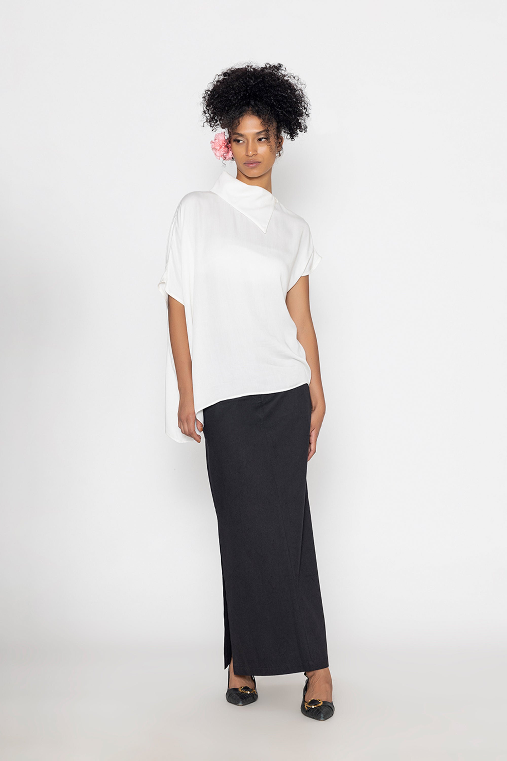Stylera trendy minimalist women’s top in white paired with a long black skirt