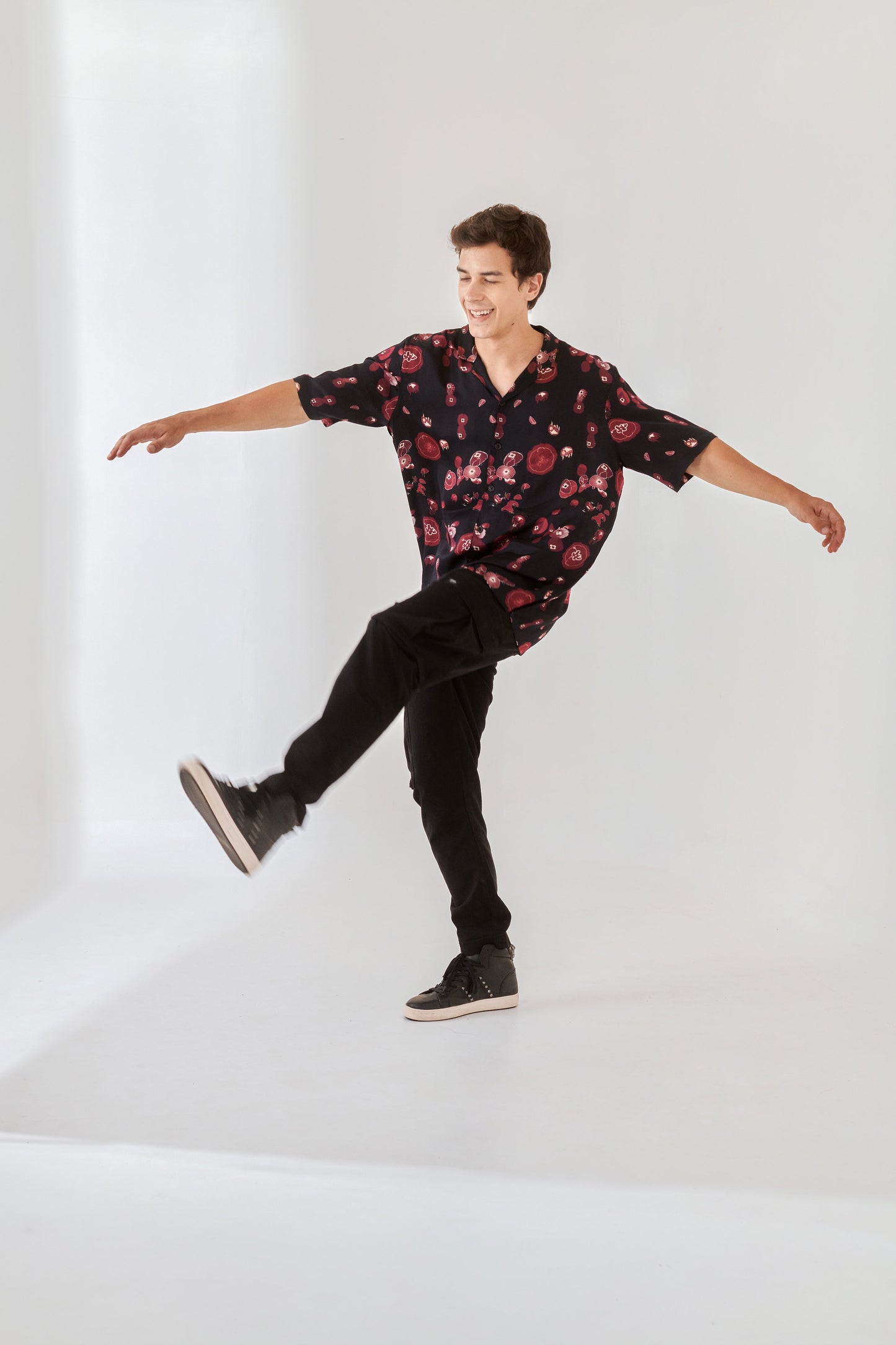 Trendy oversized button up shirt in floral design worn casually with black pants for a stylish look
