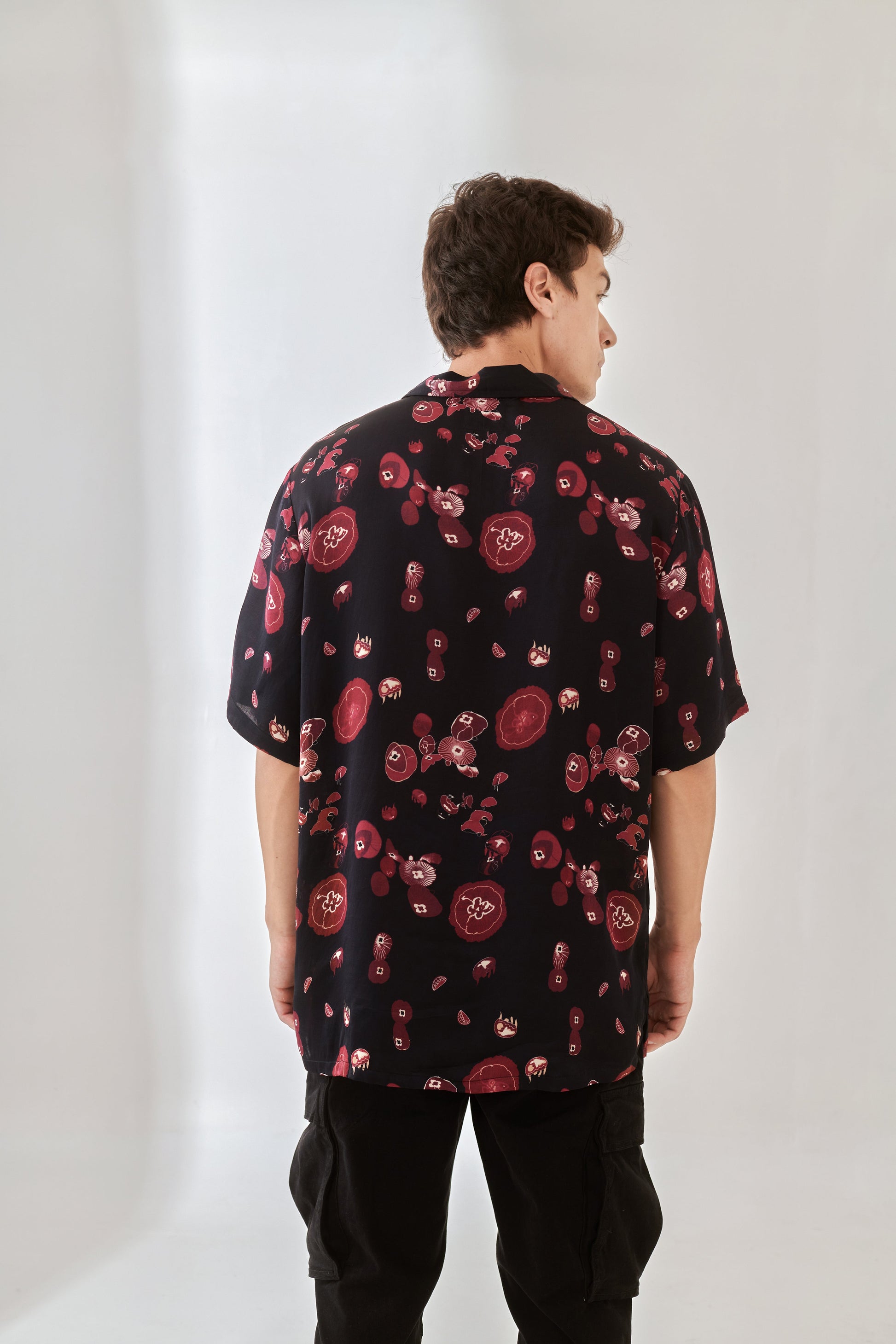 Back view of trendy oversized button up shirt from Stylera with colorful floral pattern