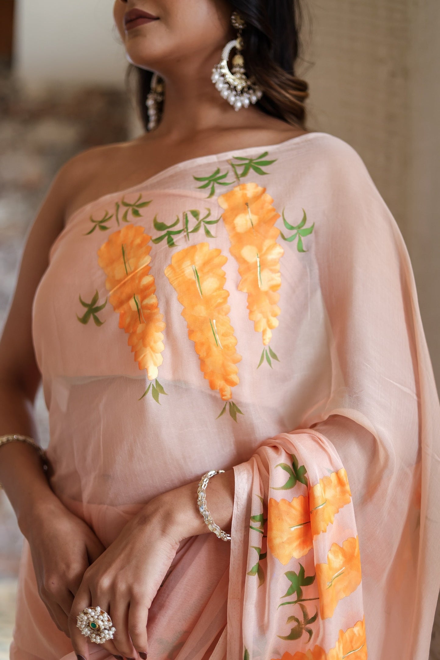 Trendy peach saree with floral design featuring vibrant embroidery and elegant draping