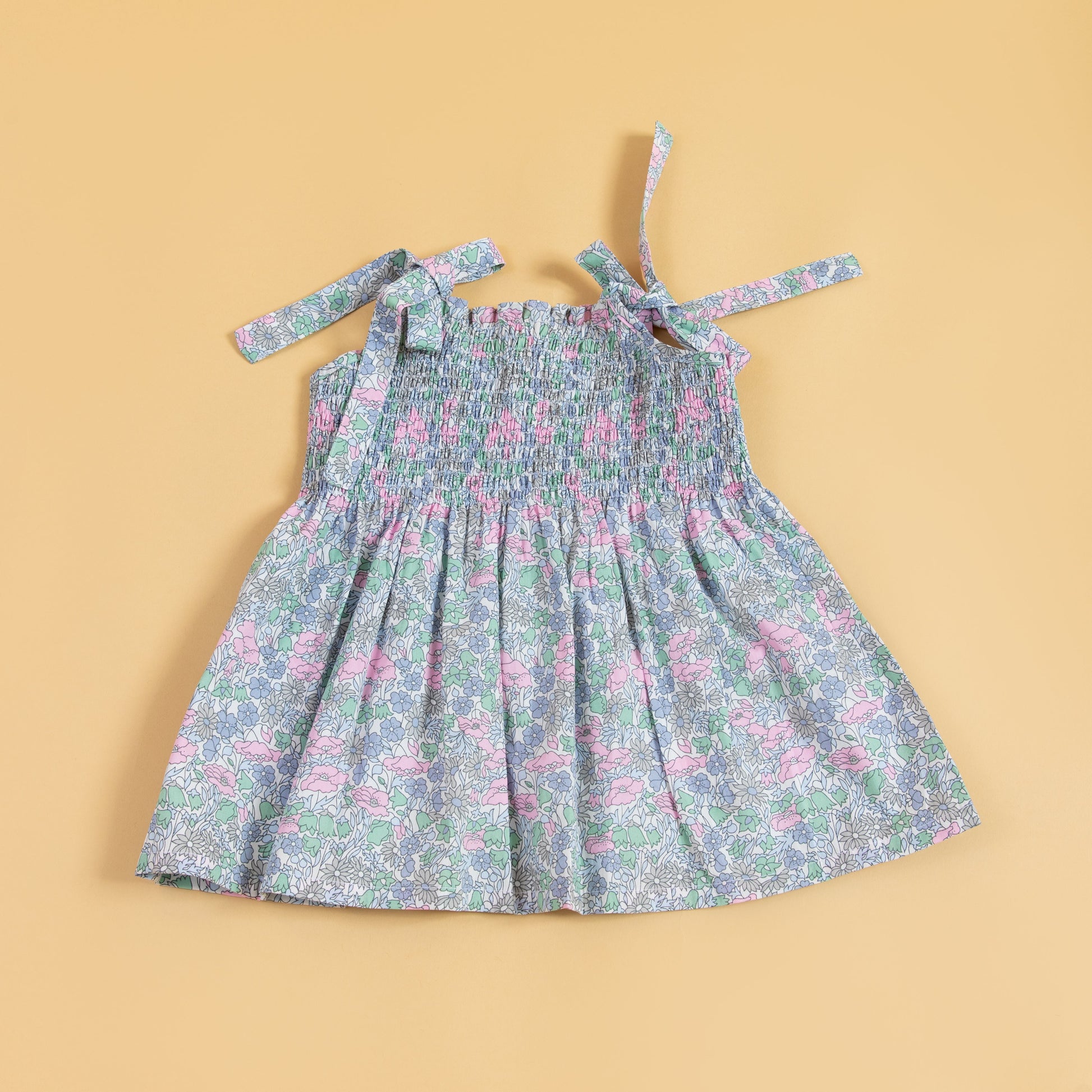 Trendy pink casual dress with floral pattern and adjustable tie straps for comfort