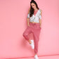 Model wearing trendy pink sweatpants paired with a stylish cropped top against a pink backdrop