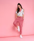 Model wearing trendy pink sweatpants paired with a stylish cropped top against a pink backdrop