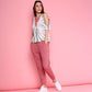 Model wearing trendy pink sweatpants paired with a stylish top against a pink backdrop