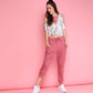 Trendy pink sweatpants with a relaxed fit, styled with a casual crop top and white sneakers