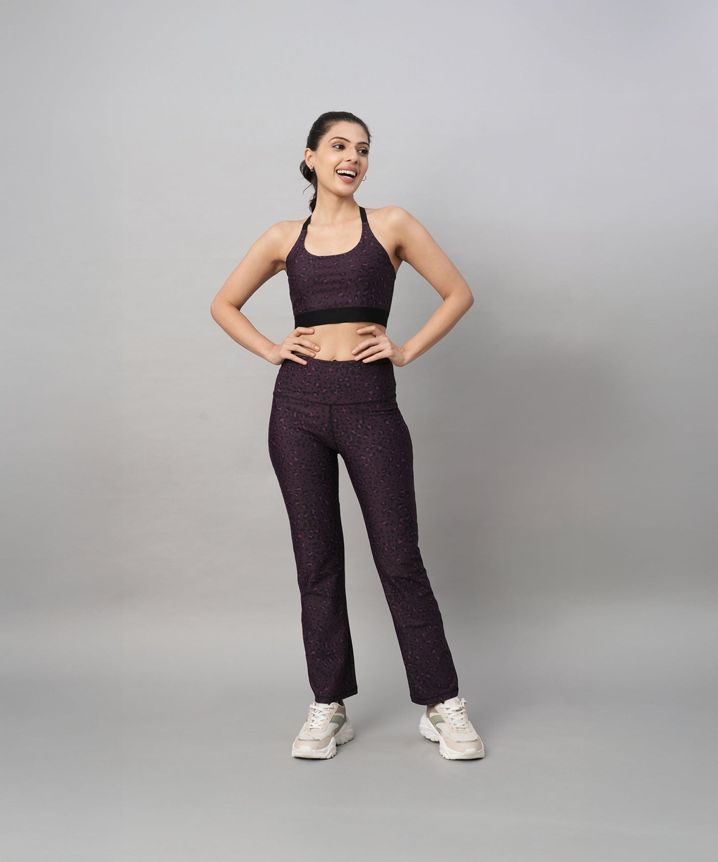 Model wearing trendy pink yoga leggings paired with a sports bra for stylish workout attire