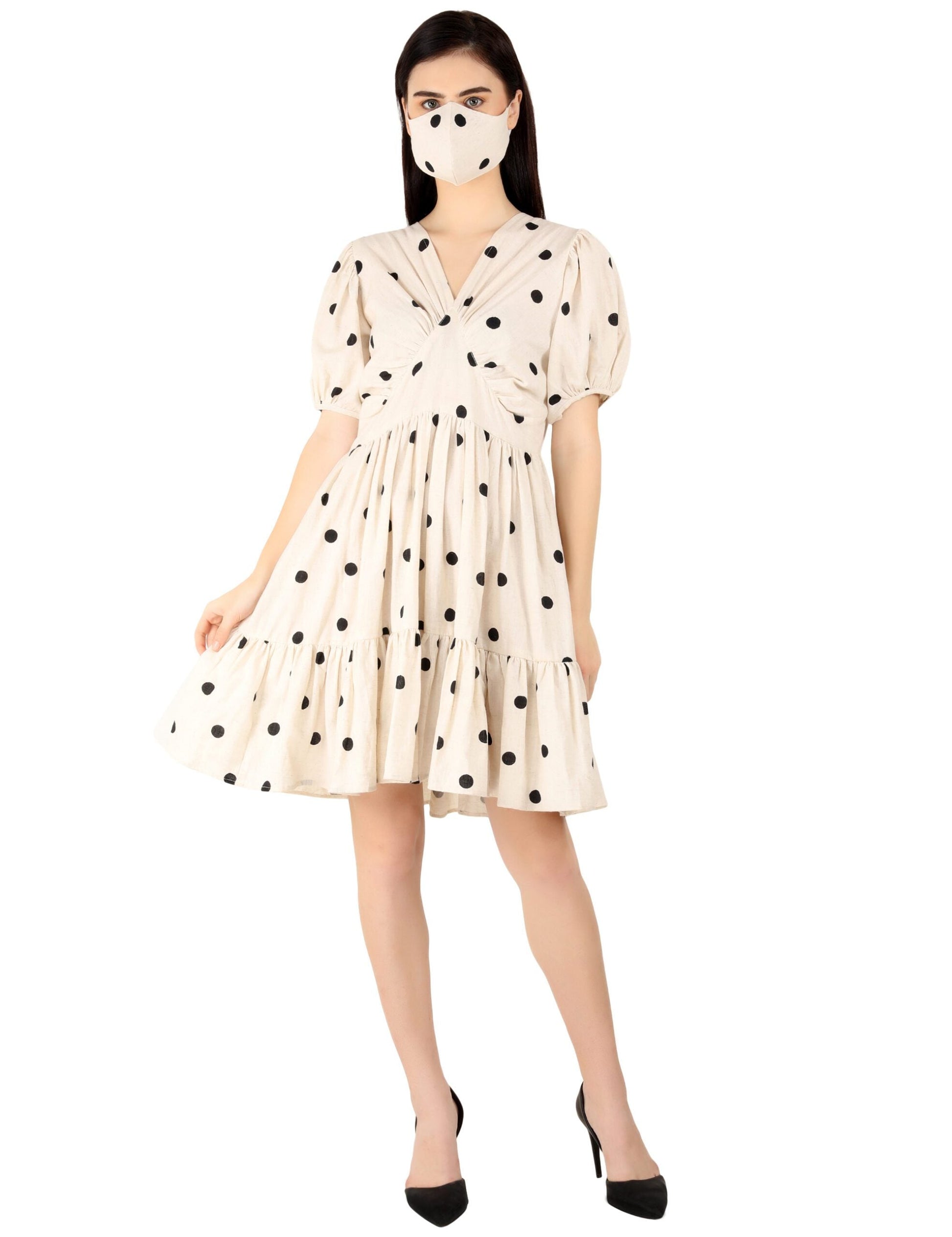 Model wearing a trendy polka dots midi dress with puff sleeves and matching face mask