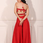 Trendy red festival wear set featuring a backless top with tassels and flowy pants for festive occasions