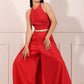 Trendy red festival wear set featuring a halter neck top and wide-leg pants for a stylish look
