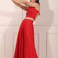 Trendy red festival wear set featuring a strapless crop top and flowing maxi skirt