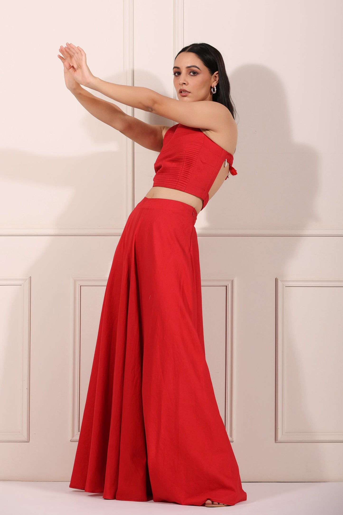 Trendy red festival wear set featuring a strapless crop top and flowing maxi skirt