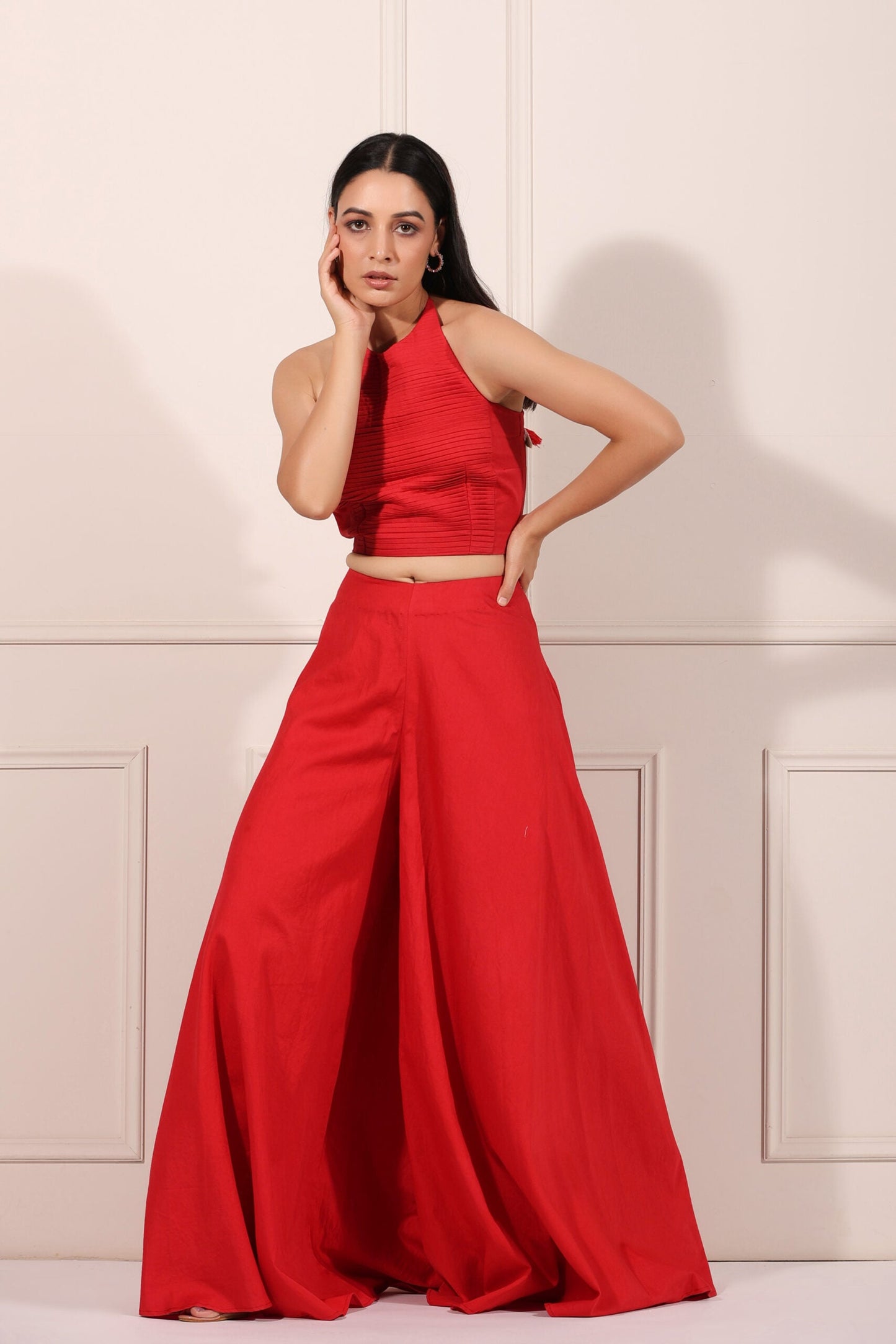 Trendy red festival wear set featuring a stylish crop top and wide-legged pants for festive celebrations