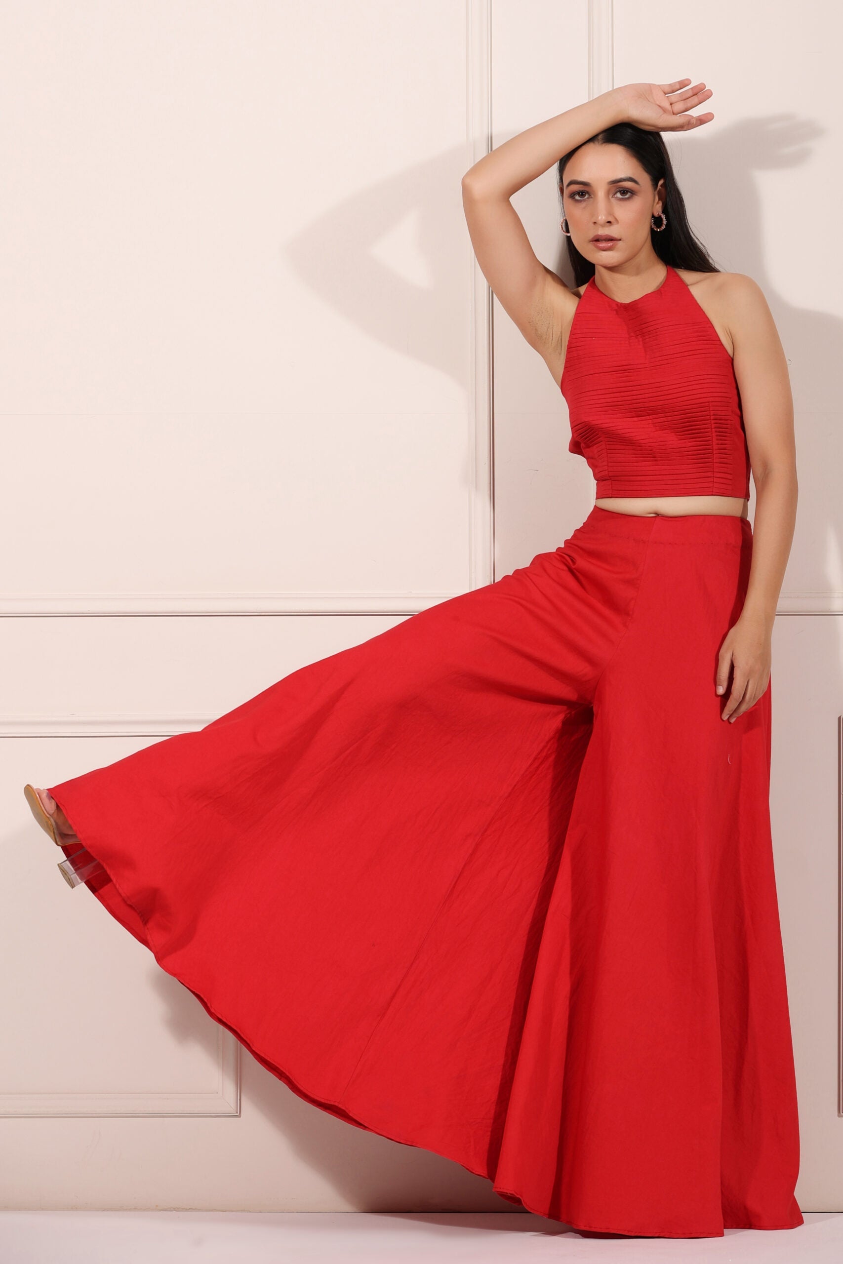 Trendy red festival wear set featuring a stylish crop top and wide-leg pants for festive occasions