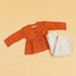 Trendy rust peplum top and pants set with button details and stylish stripes