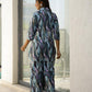 Woman wearing trendy satin pajamas set with a colorful abstract design, perfect for stylish loungewear