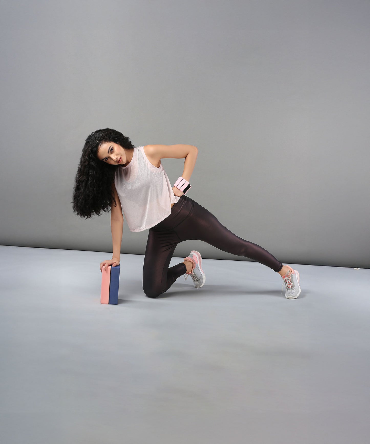 Model demonstrating yoga poses in a trendy sheer crop top for women with stylish leggings
