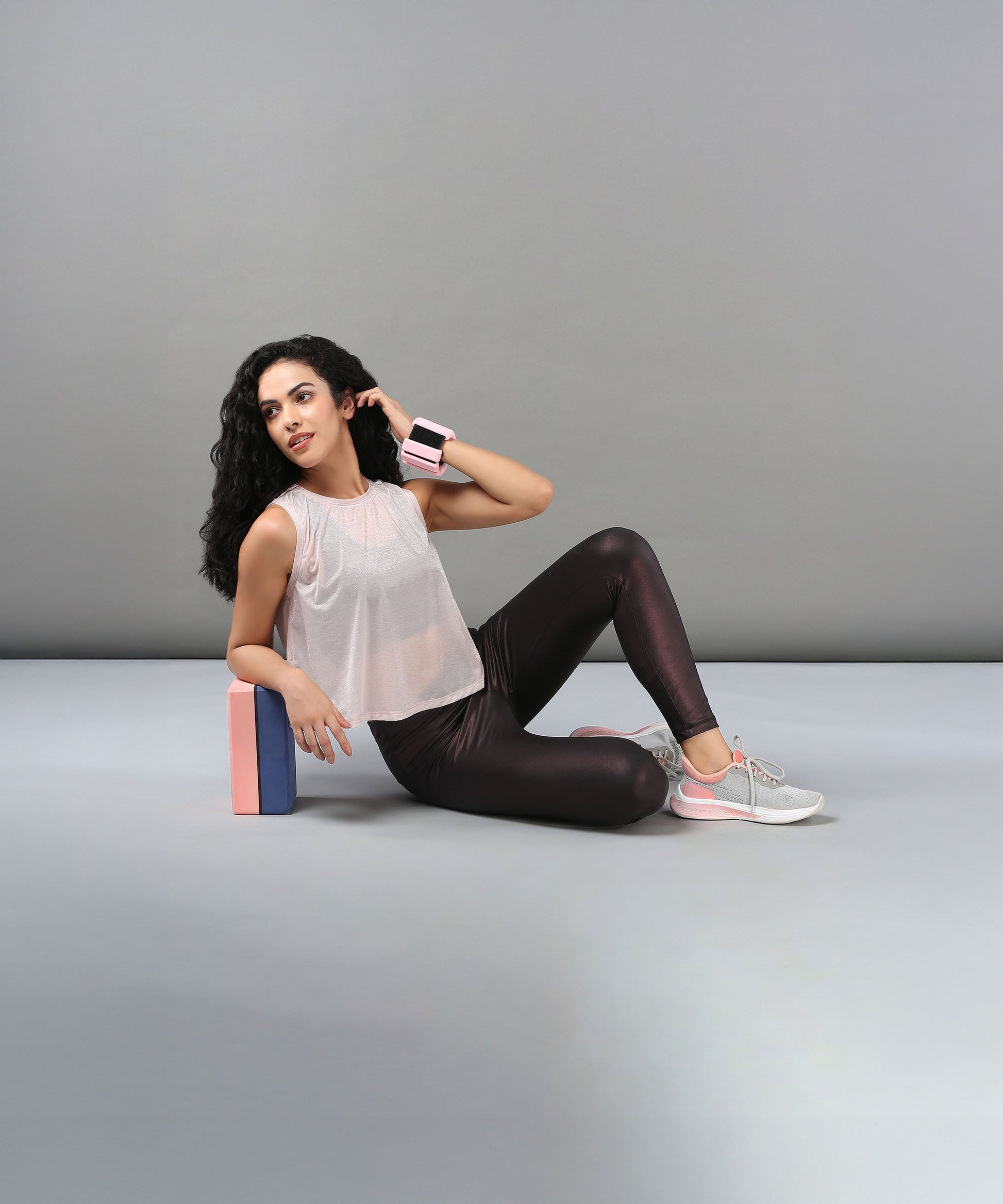 Model wearing trendy sheer crop tops for women, paired with sleek leggings and sports shoes