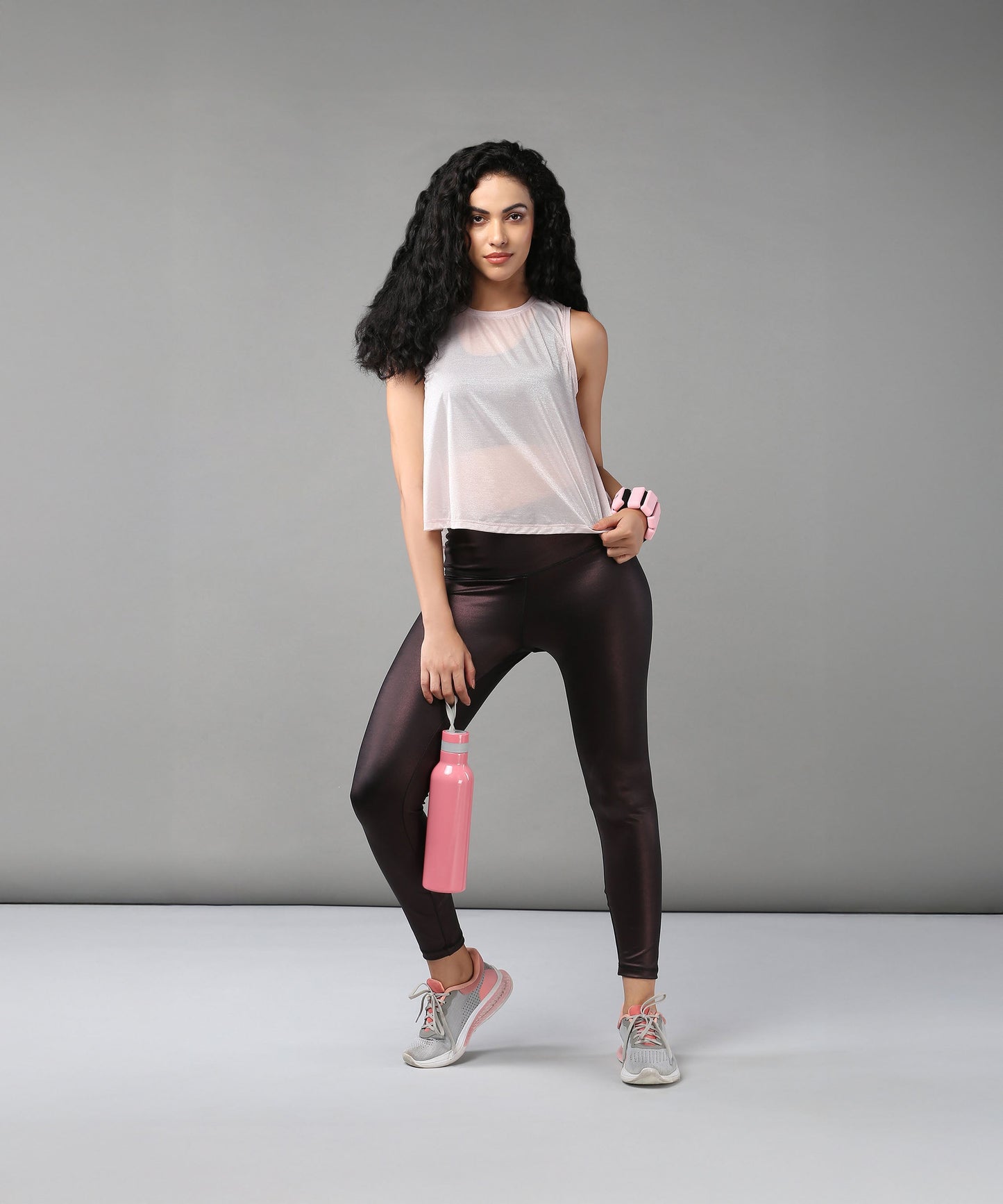 Trendy sheer crop tops for women styled with high-waisted leggings and a water bottle