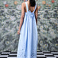 Stylera light blue trendy sleeveless maxi dresses style shown from back with tie straps and floral cutout hem