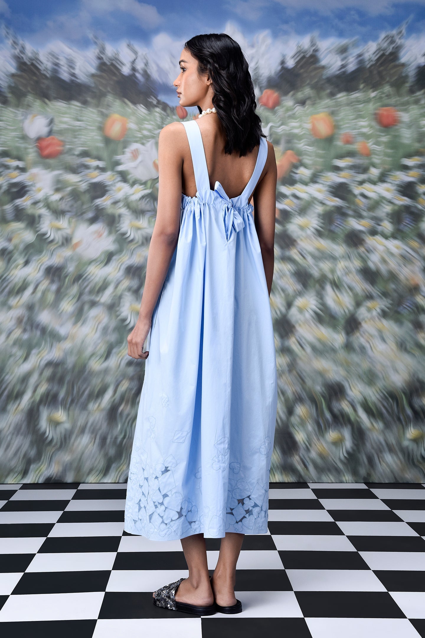 Stylera light blue trendy sleeveless maxi dresses style shown from back with tie straps and floral cutout hem