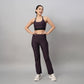 Model wearing trendy sports bras with back design and matching patterned workout pants