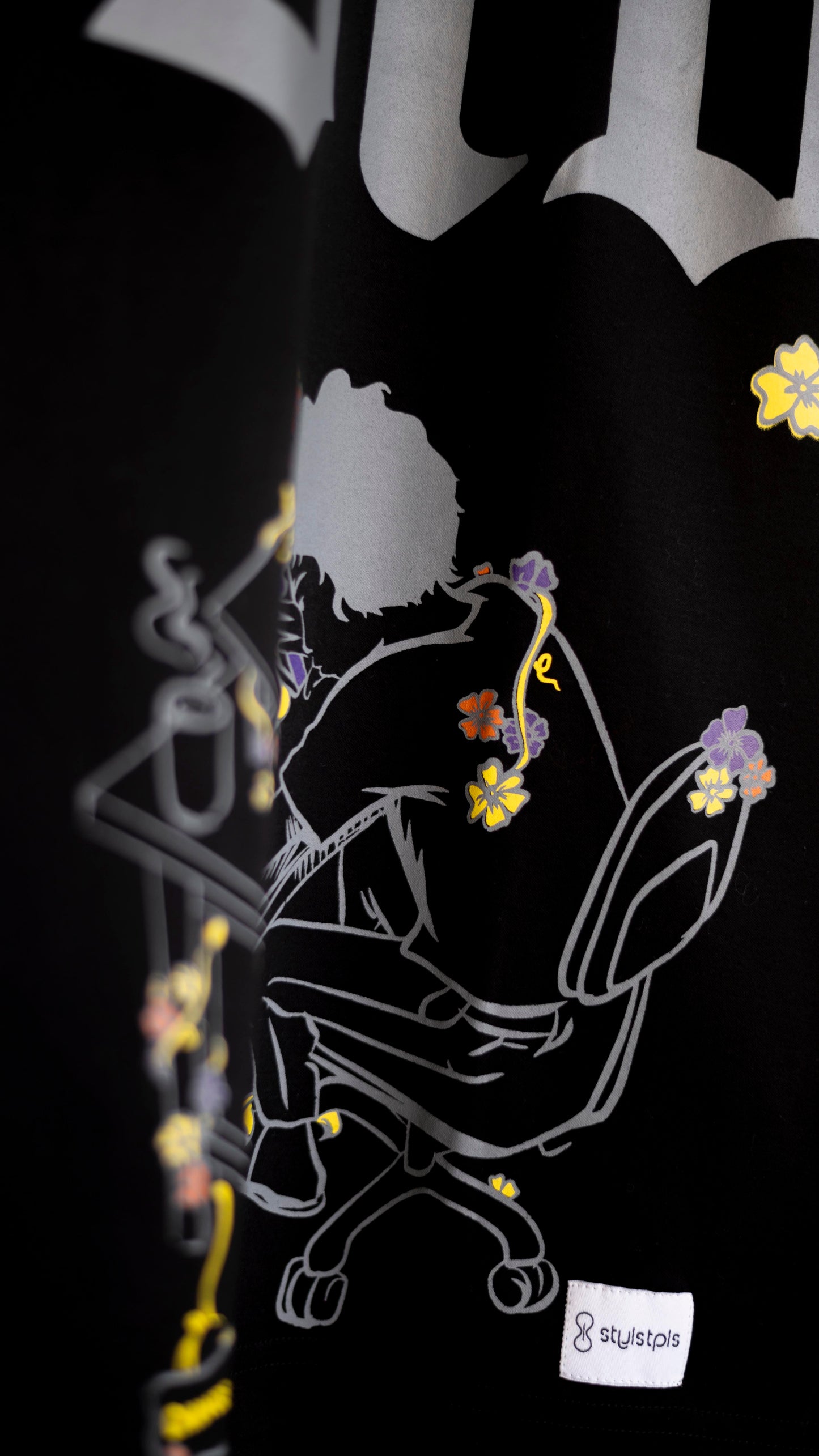 Stylstpls trendy streetwear black t-shirt featuring a graphic design with colorful floral accents