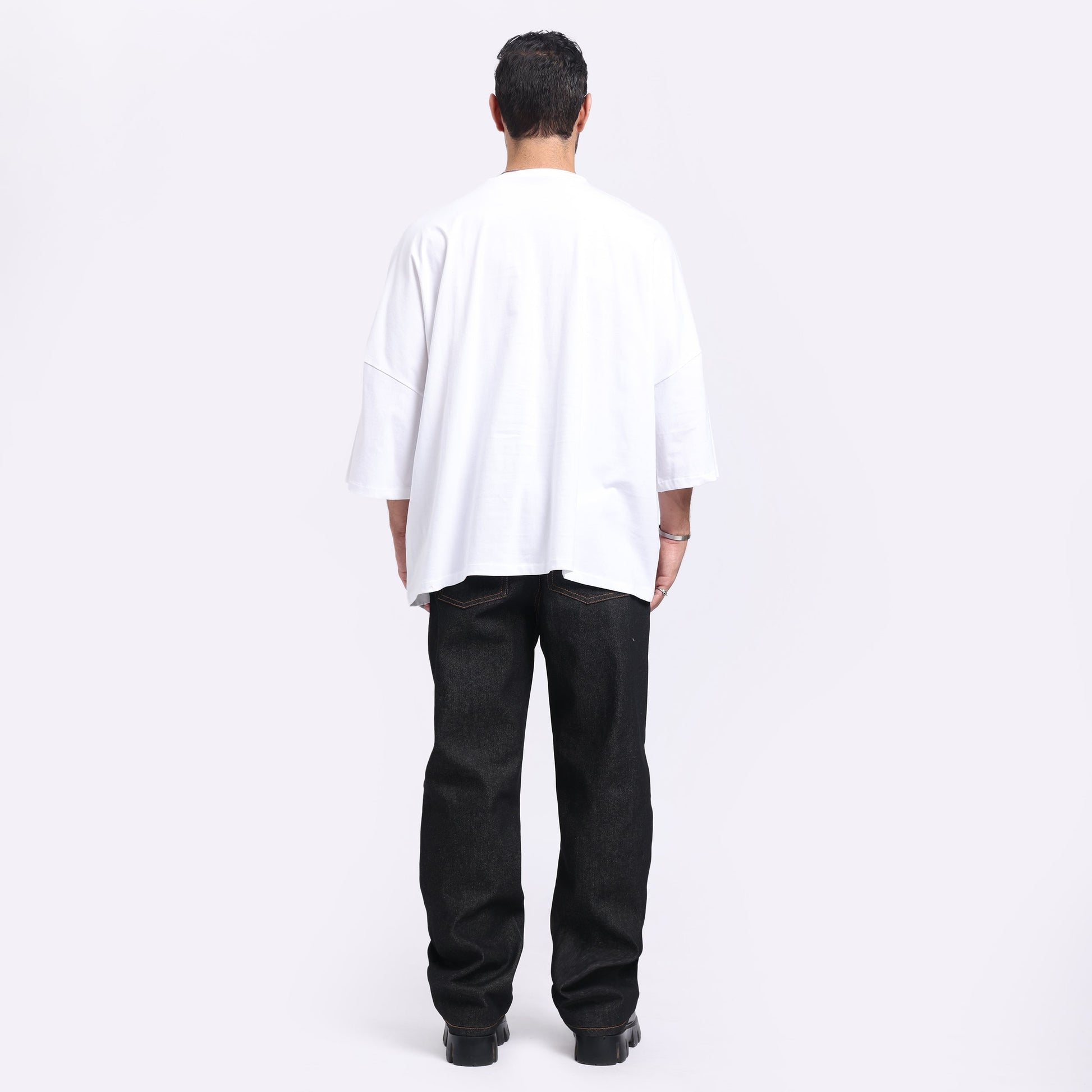 Back view of Stylera trendy streetwear t-shirt men in white fabric paired with black jeans
