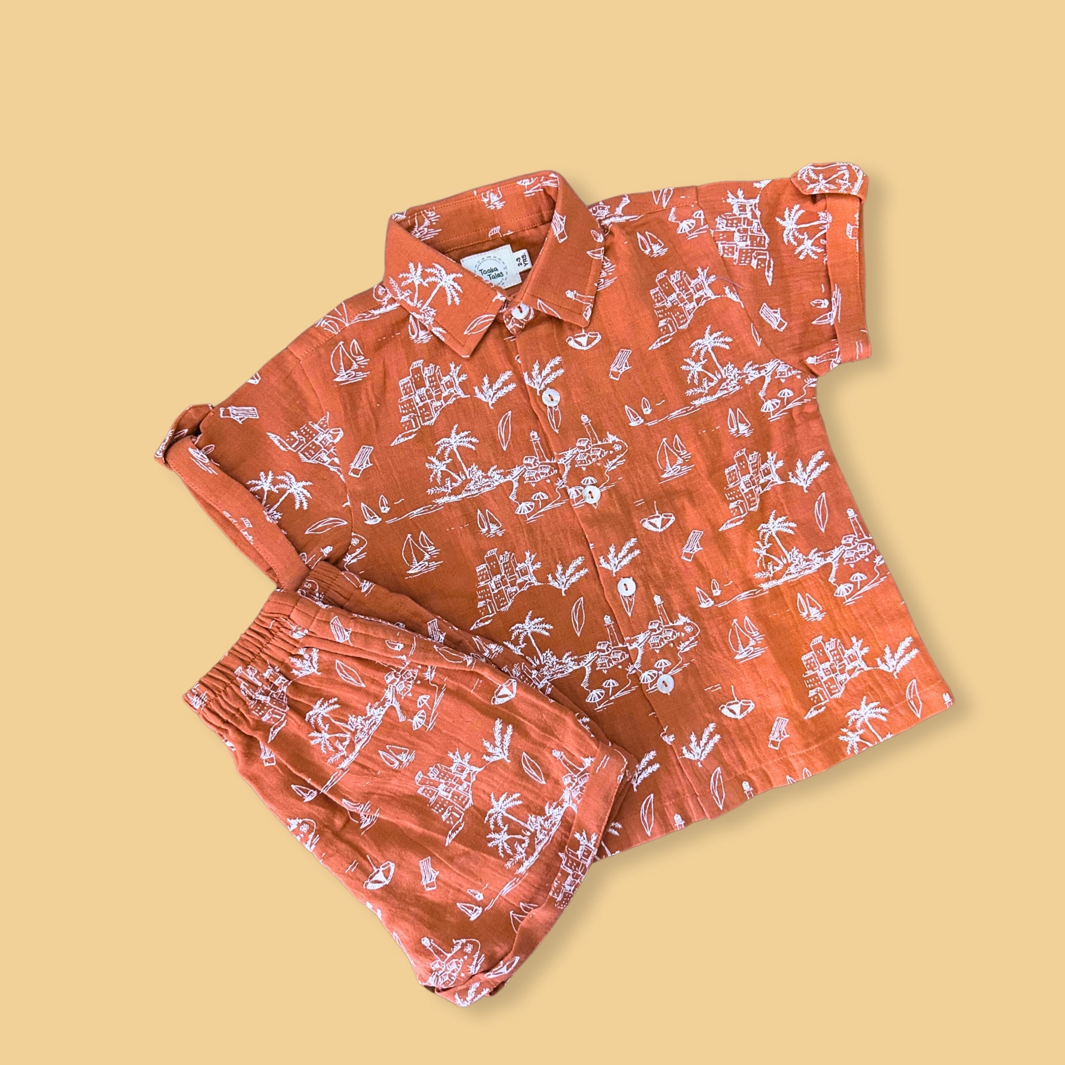 Trendy summer clothes for boys featuring an orange Hawaiian print shirt and matching shorts