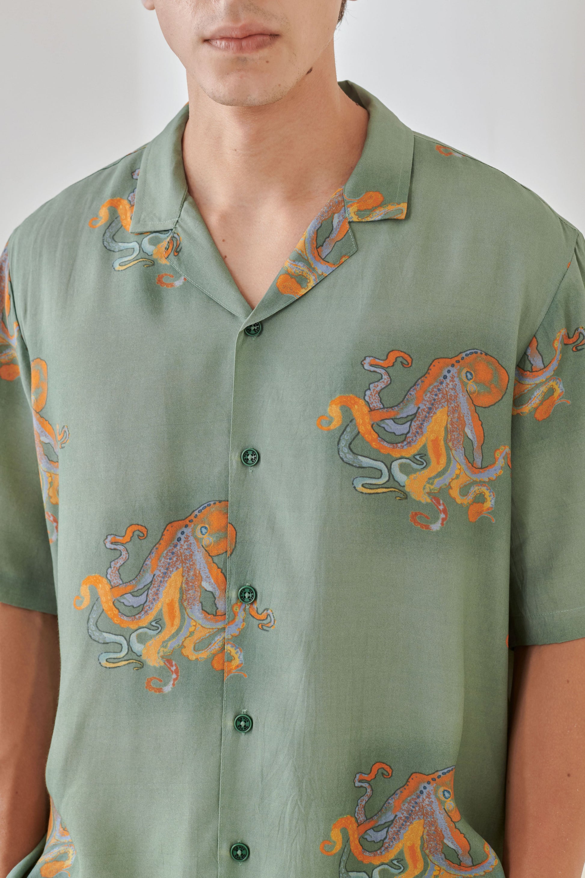 Trendy summer oversized shirt for men featuring a vibrant octopus print on a green background
