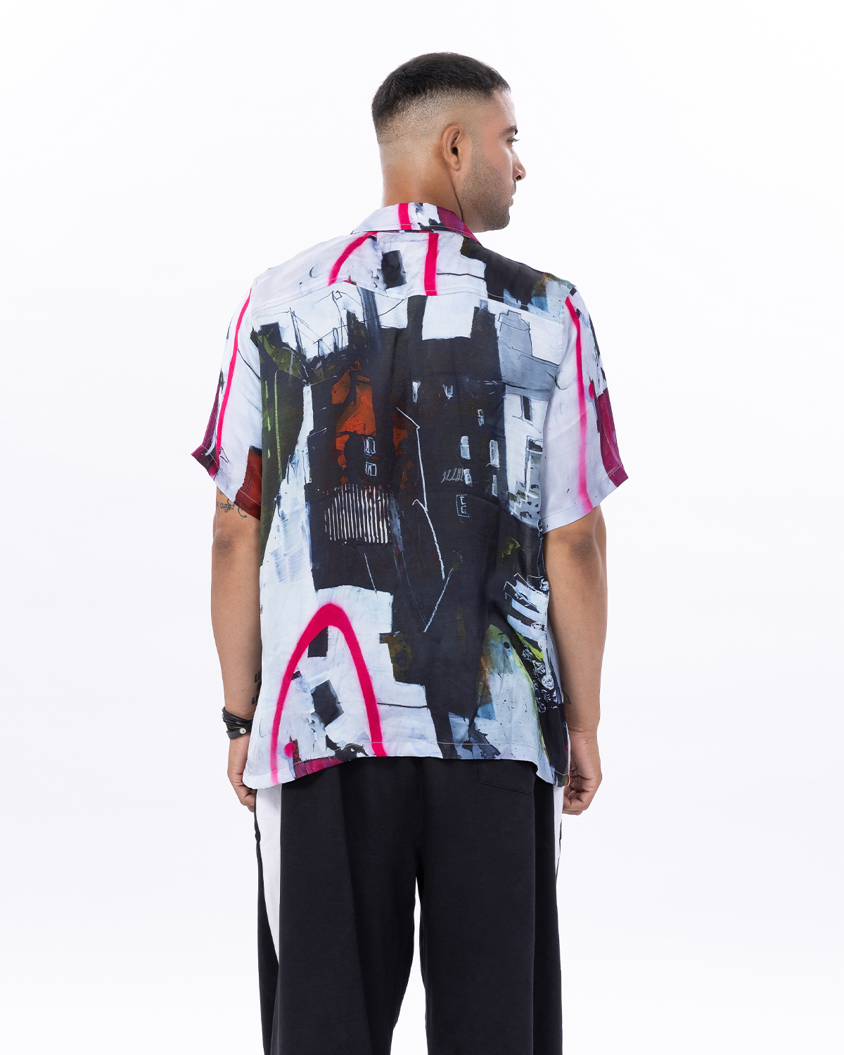 Stylish man wearing a trendy summer short sleeve shirt with abstract art design on the back