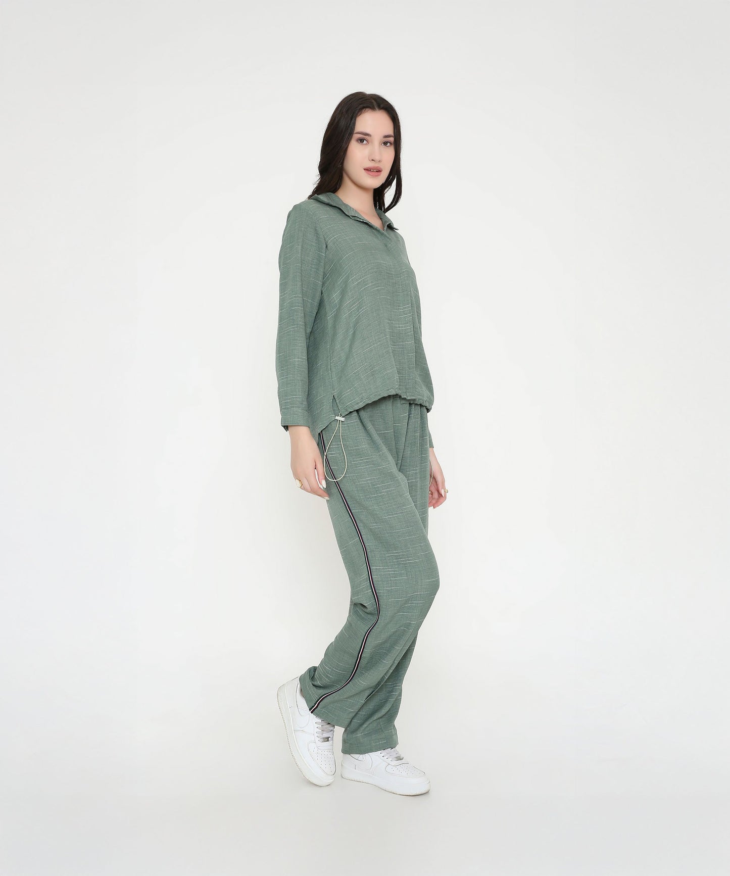 Model wearing a trendy two piece cord set in green for a stylish casual look