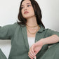 Model wearing a trendy two piece cord set in green, featuring a relaxed fit and stylish design