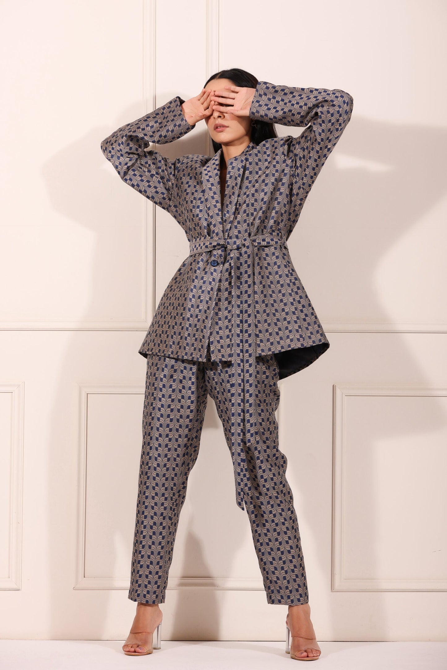 Trendy two piece pant suit women in stylish geometric pattern with belted jacket and matching pants