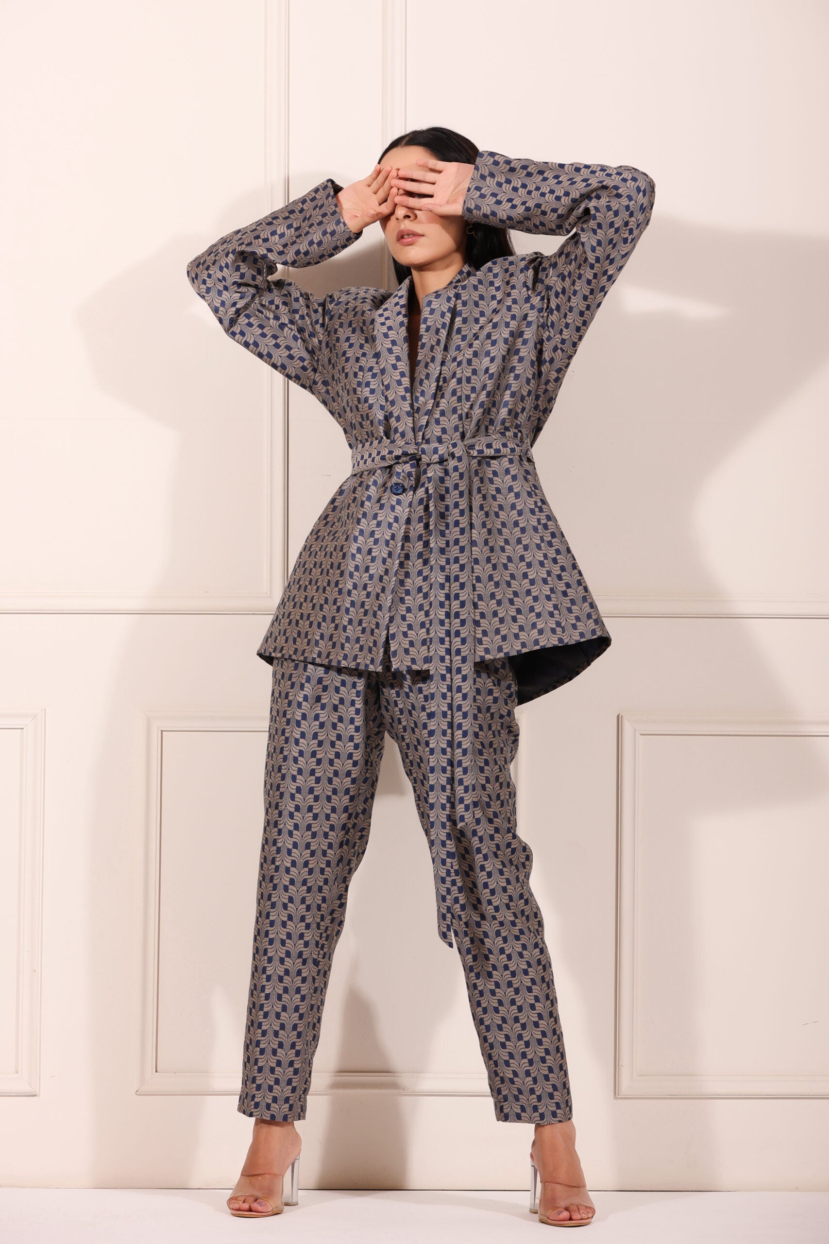 Trendy two piece pant suit women in stylish geometric pattern with belted jacket and matching pants
