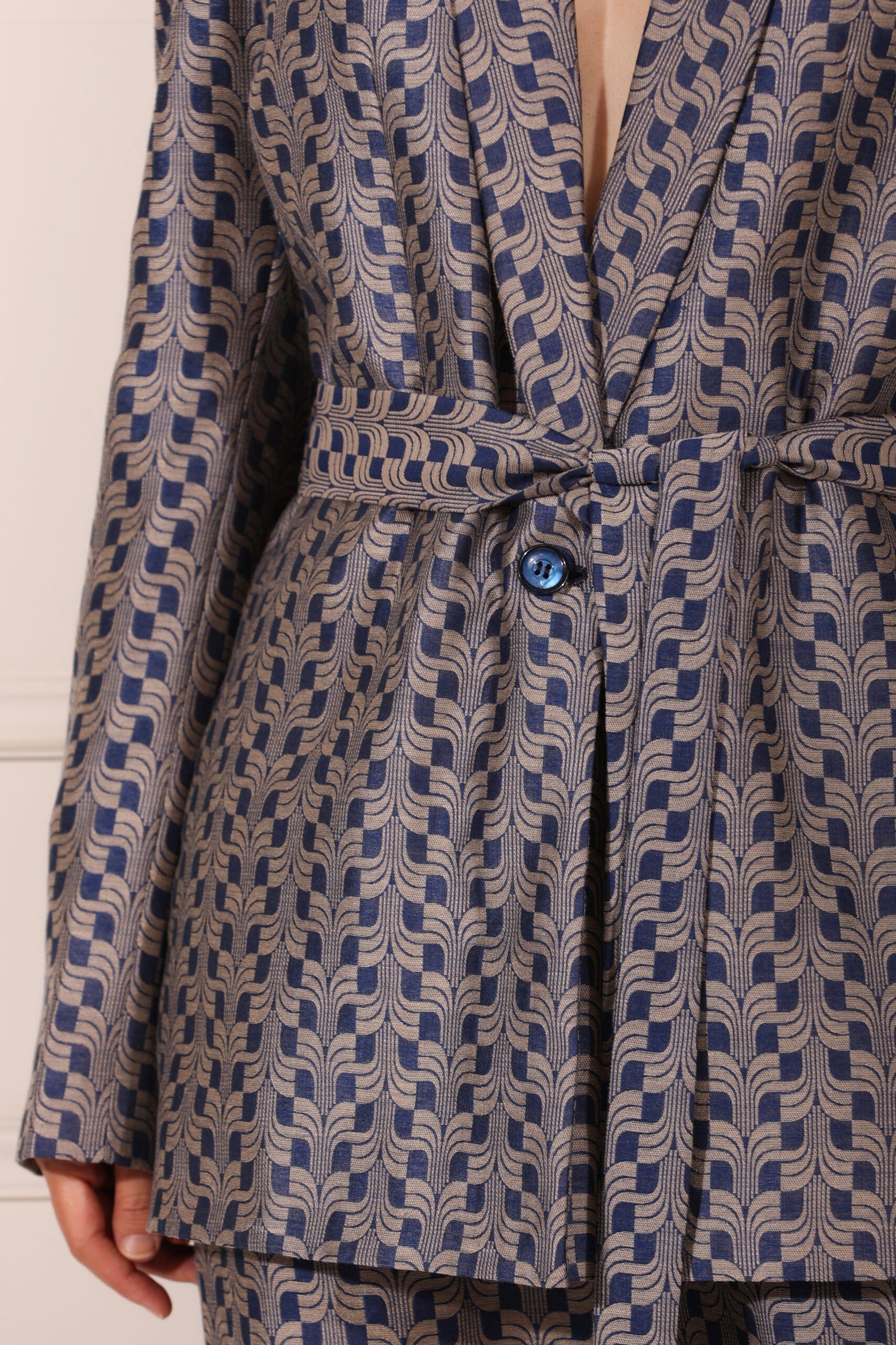 Trendy two piece pant suit women with stylish patterned fabric and a belted blazer design